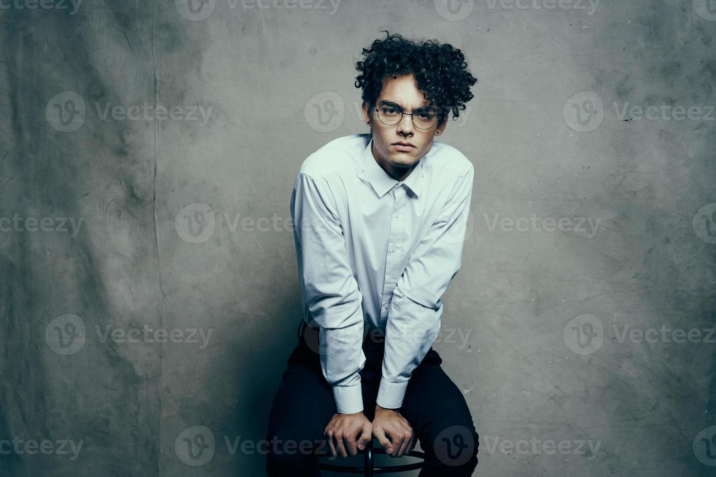 Rizado pelo joven hombre en camisa clásico traje fotografía estudio modelo en tela antecedentes foto