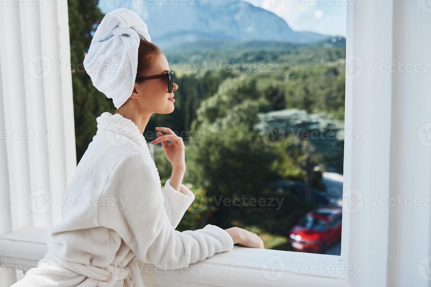 Portrait woman in a bathrobe in the morning on the balcony admiring nature Lifestyle photo