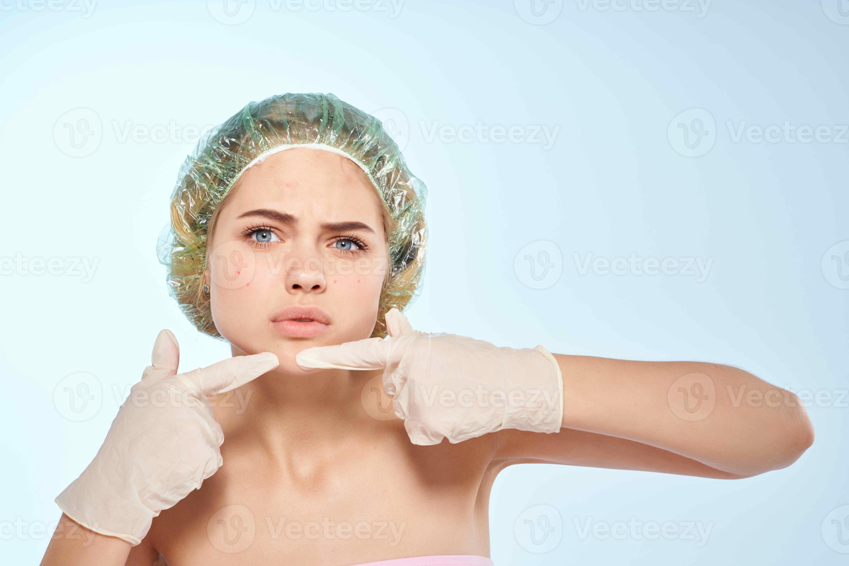 woman with bare shoulders squeeze pimples on her face dermatology