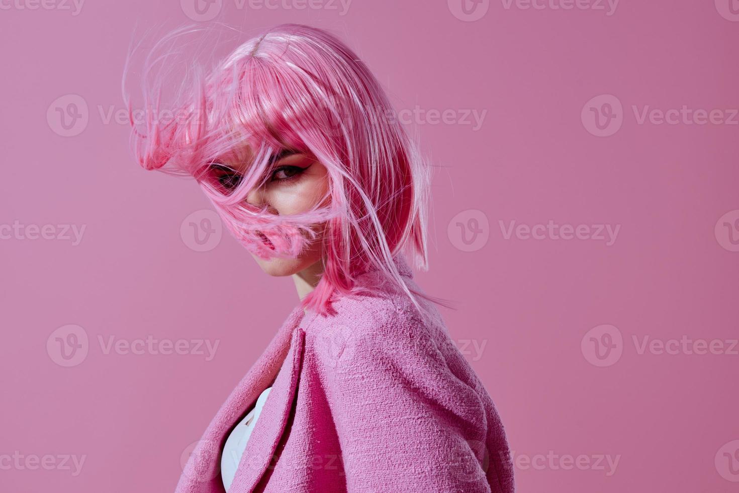 Positive young woman pink jacket holding hair cosmetics pink background unaltered photo