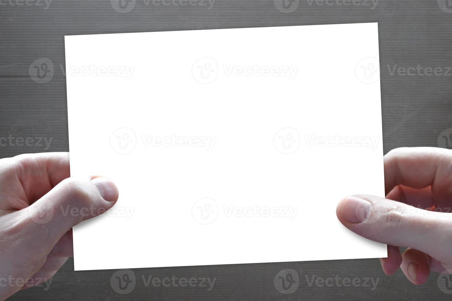 Human Hands Holding Empty White Piece of Paper - Presentation Concept photo