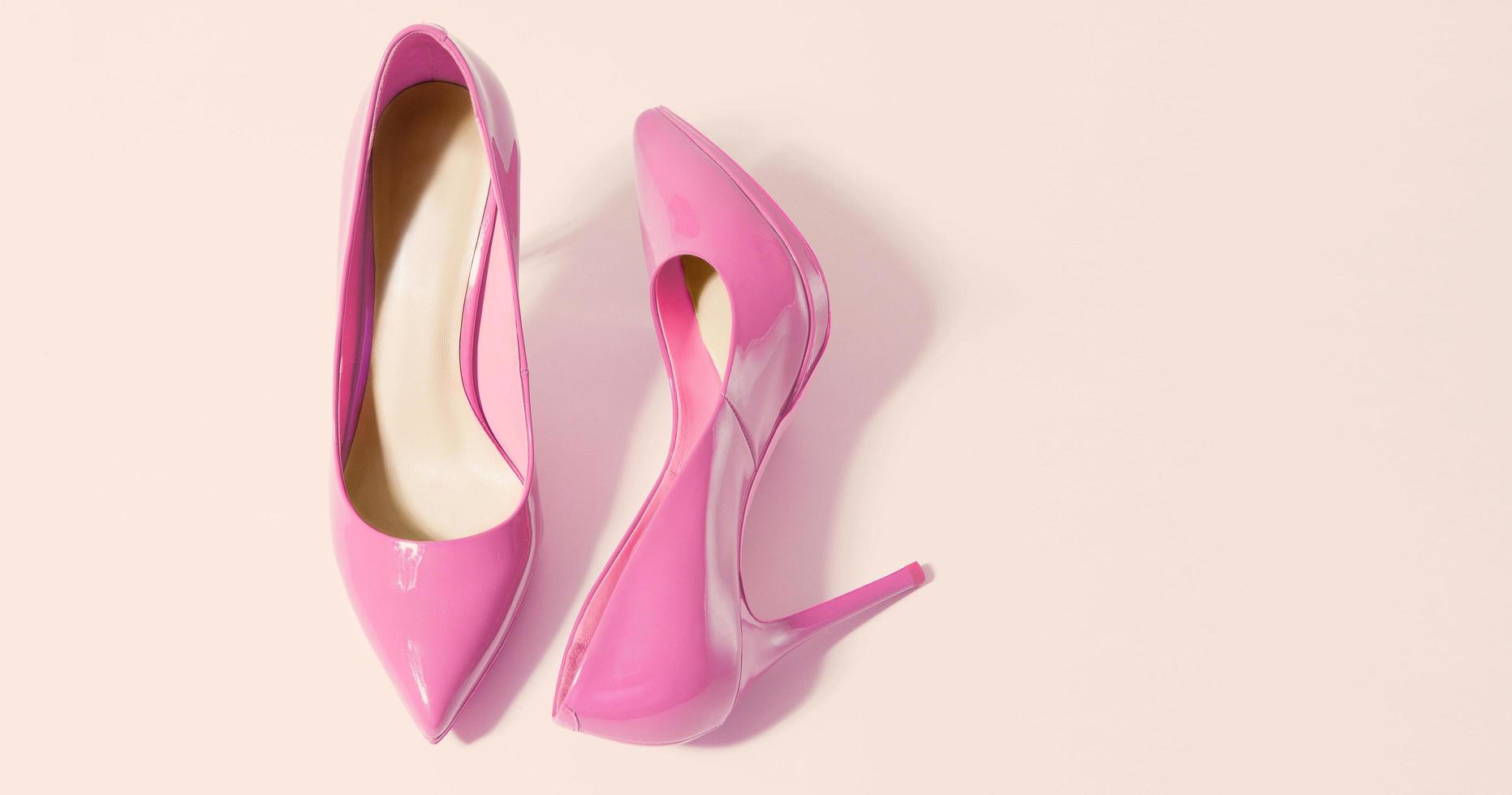 Woman Shoes Banner. High heels closeup. Top view. Women fashion. Ladies accessories. Girly casual formal shoe isolated. pink background. Footwear on floor. Copy space, mockup. flat lay Selective focus photo