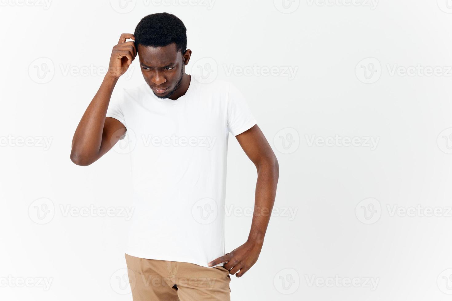 young african man tilt head down and look puzzled interested person