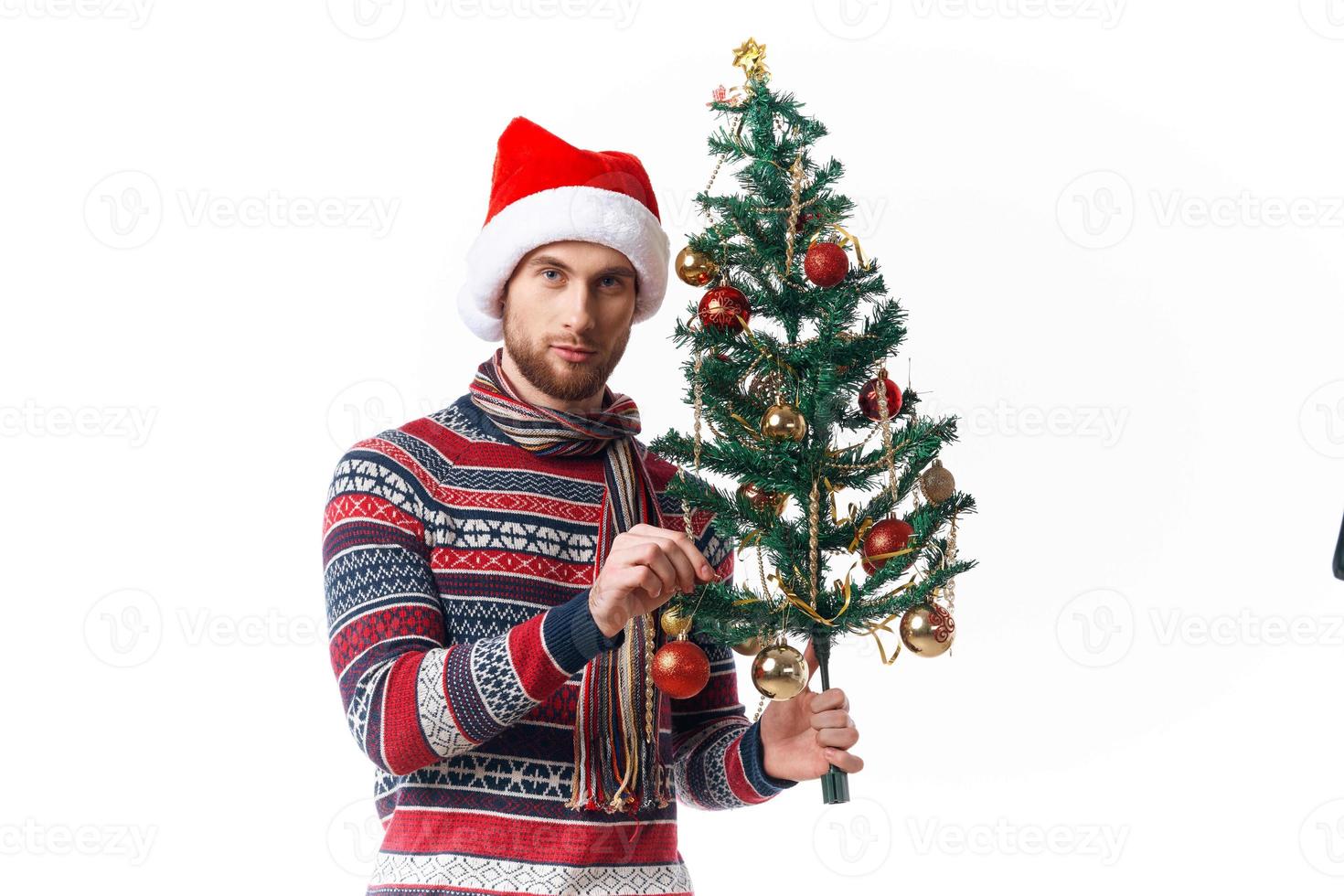 Cheerful man in New Year's clothes decoration christmas studio posing photo