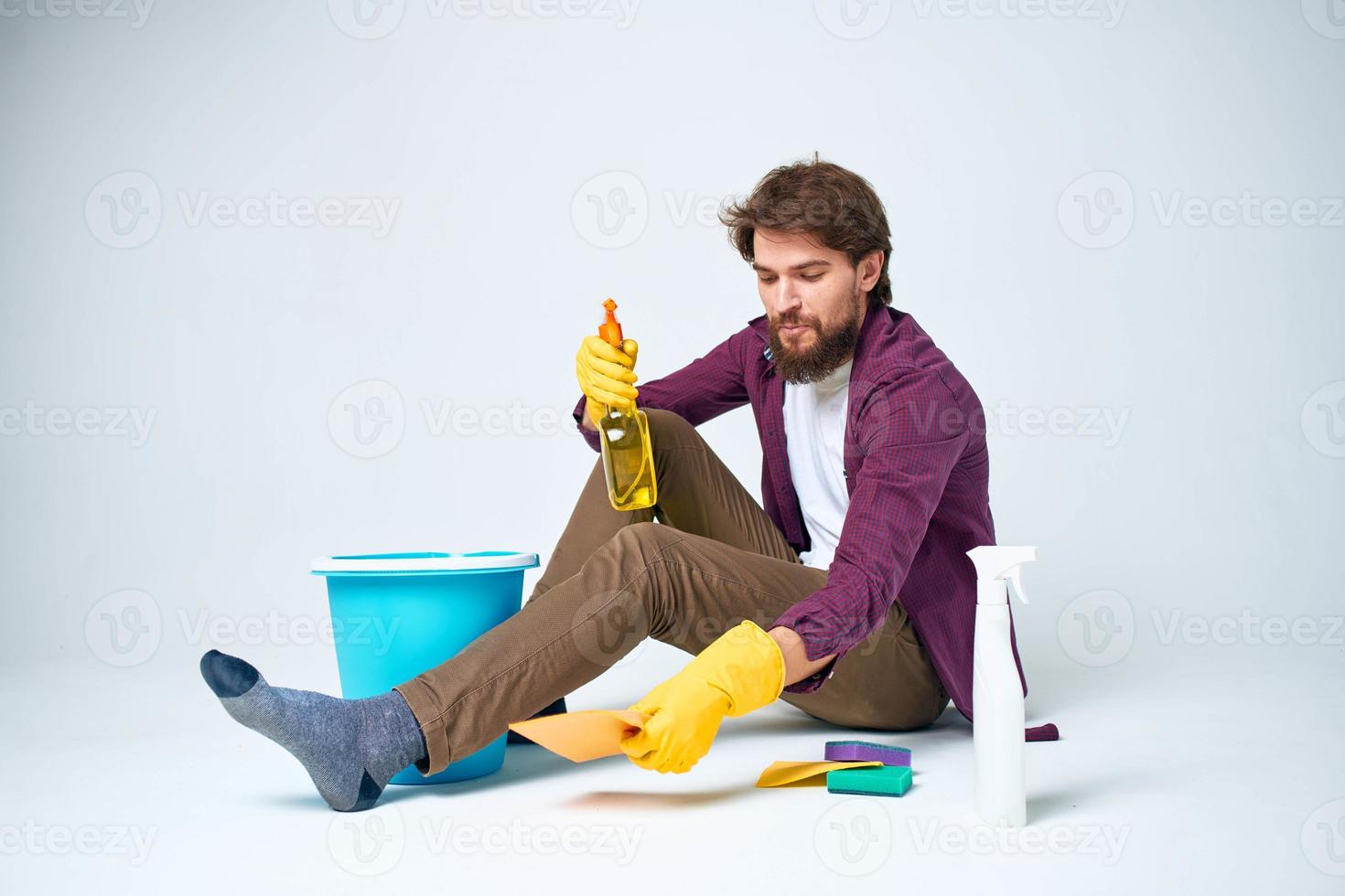 Man with detergent in the hands of a car wash providing housework hygiene services photo