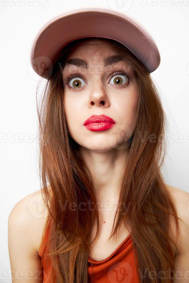 Emotional woman in a cap model with surprised expression fashionable clothes photo