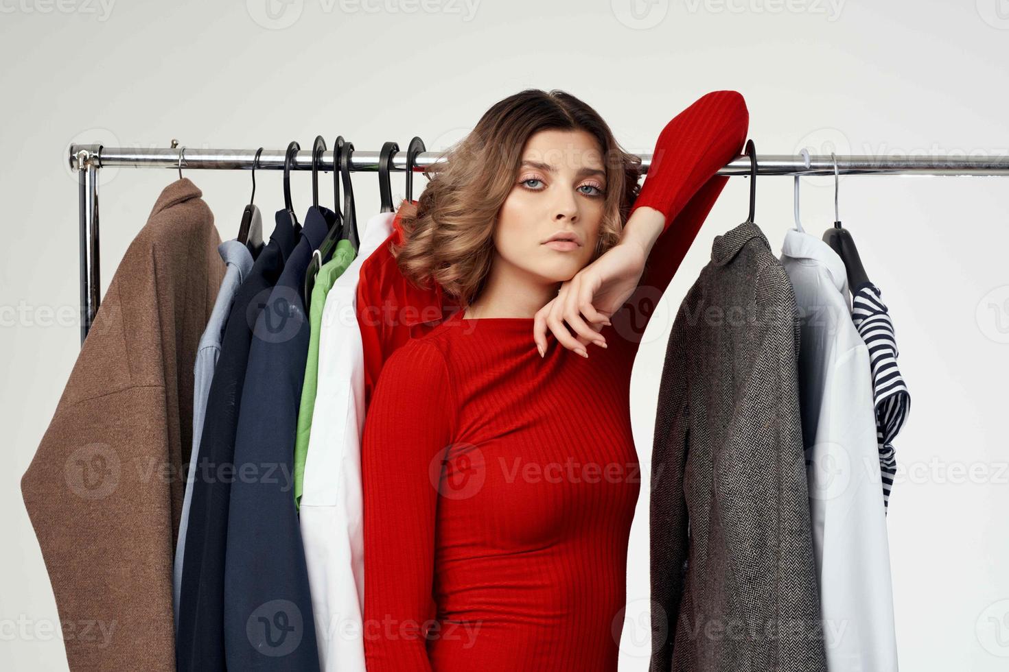 pretty woman trying on clothes shop shopaholic light background photo