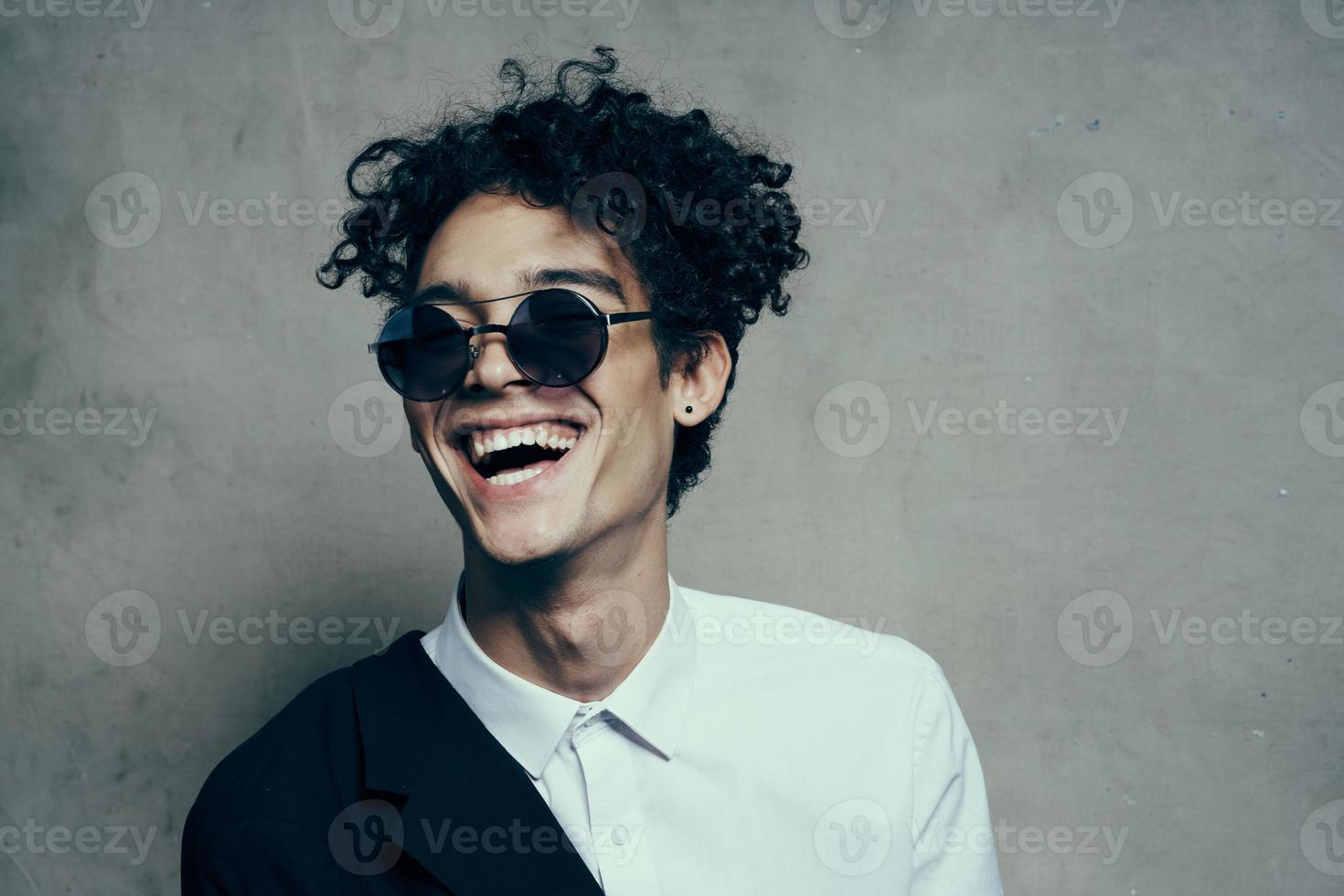 happy man dazzling smile curly hair glasses model shirt jacket photo