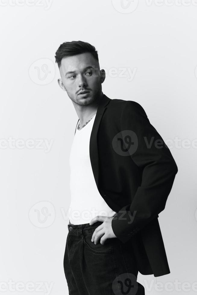 Modelling snapshots. Side of view narcissistic attractive handsome man in classic suit hold hands on belt posing isolated in white studio background. Black White concept. Fashion offer. Copy space photo
