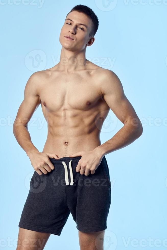 attractiveness athlete in shorts holding hands on belt inflated torso cropped view photo