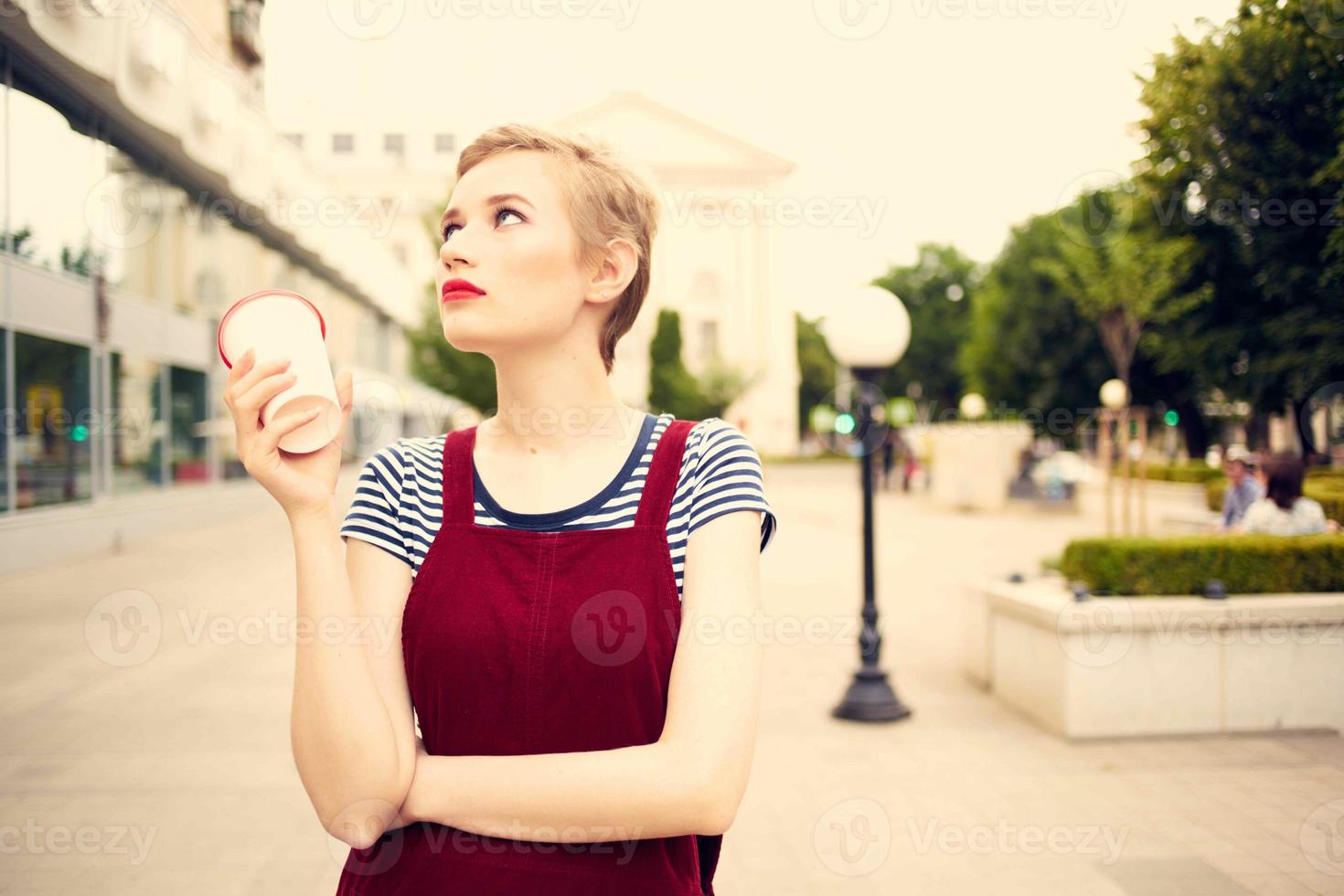 corto peludo mujer al aire libre Moda posando vaso con bebida foto