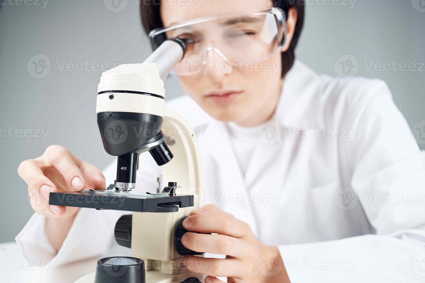 Woman in white coat laboratory microscope work science research Woman in white coat laboratory microscope work science research