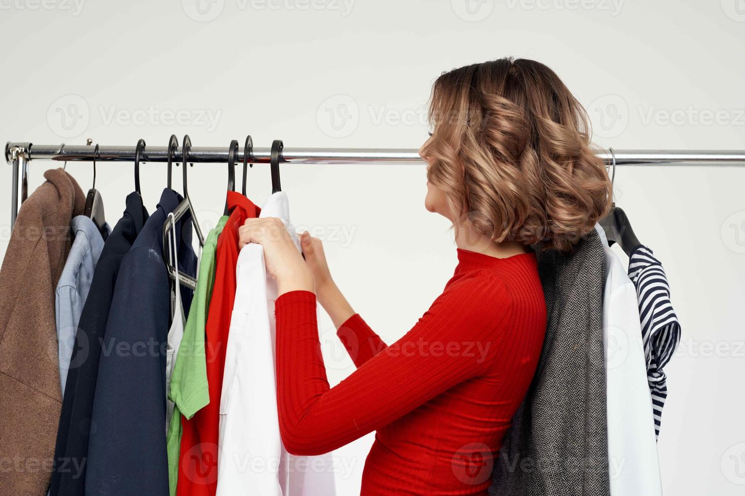 cheerful woman in a red jacket near the wardrobe emotions photo