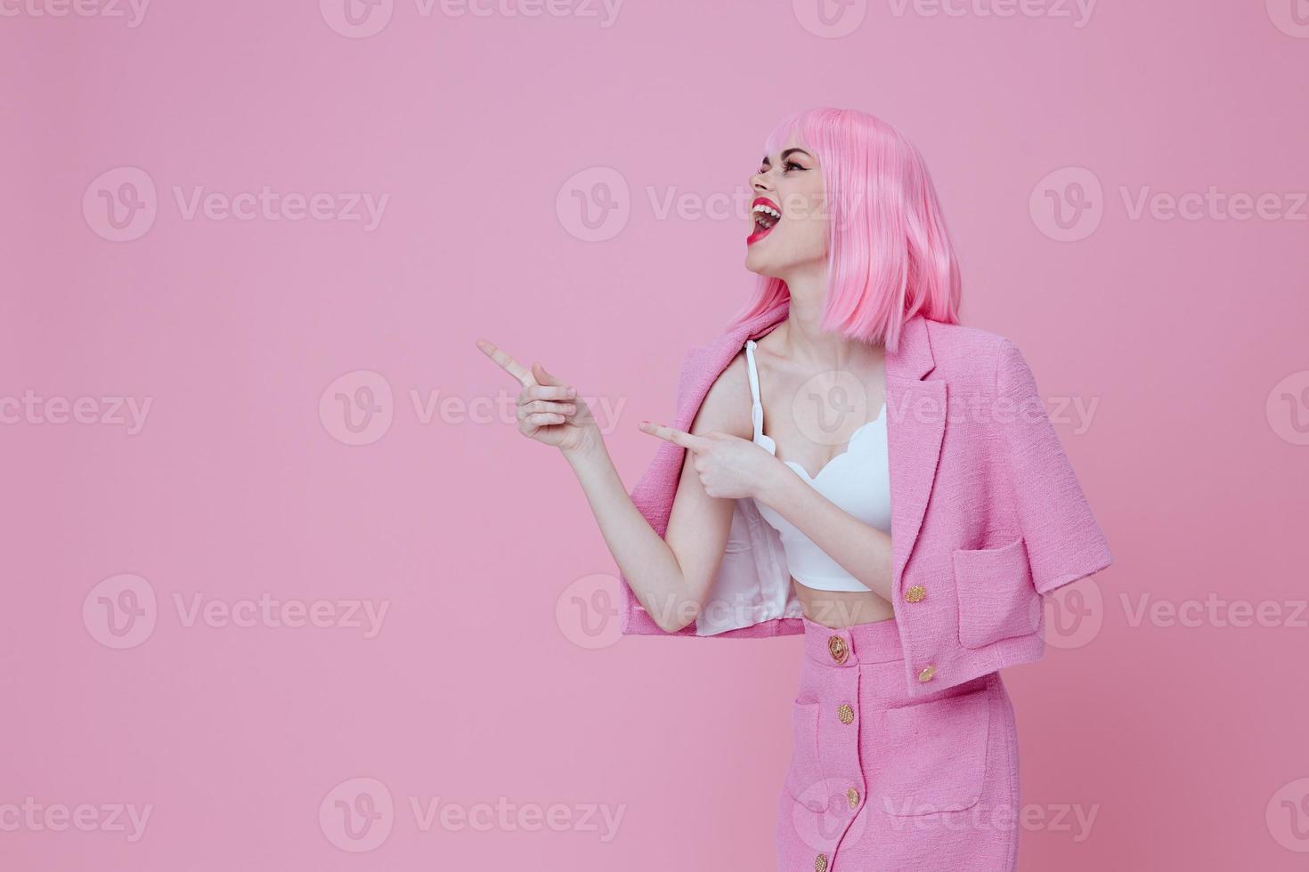 Portrait of a charming lady in a pink suit gesturing with his hands emotions fun Studio Model unaltered photo