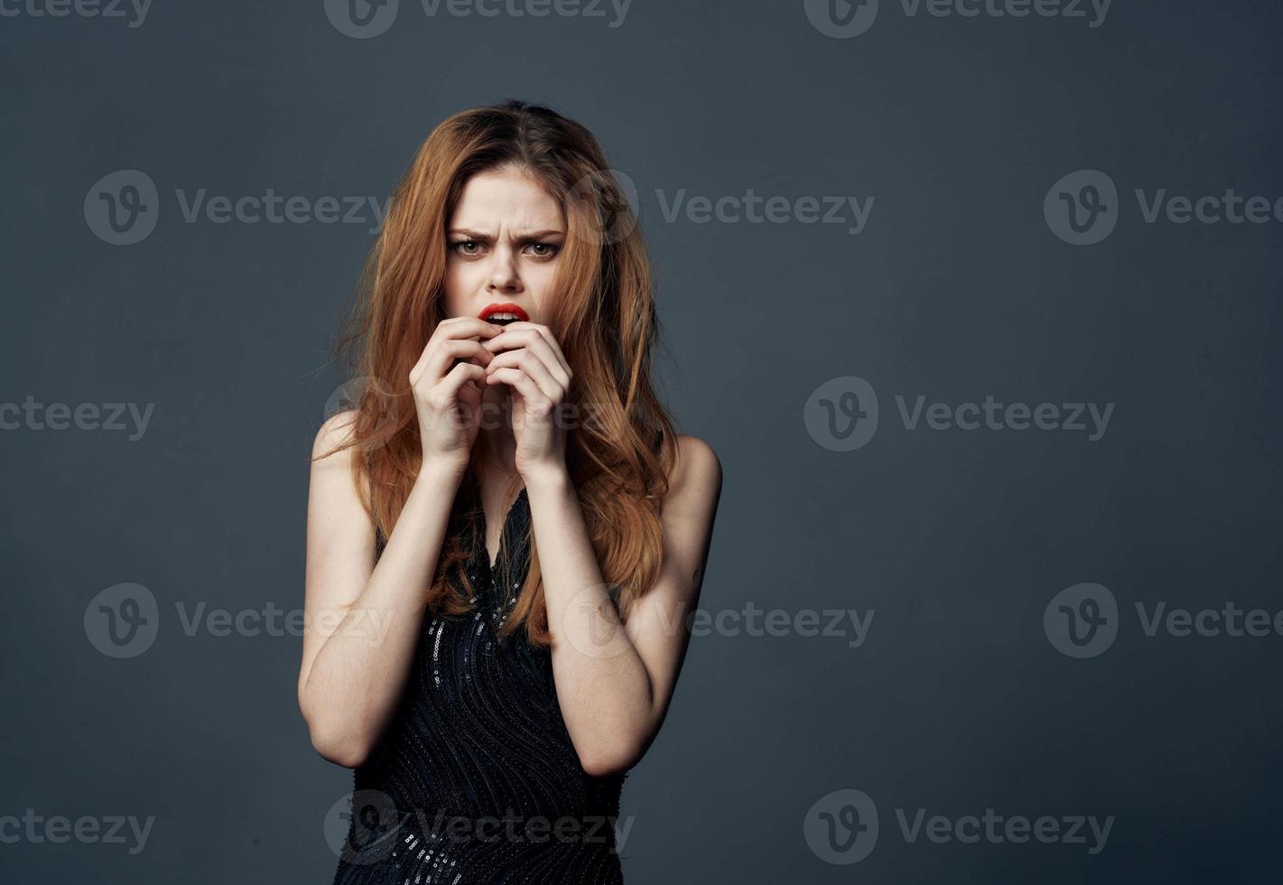 impulsive woman on a gray background indignant Look model and black dress 22071090 Stock Photo