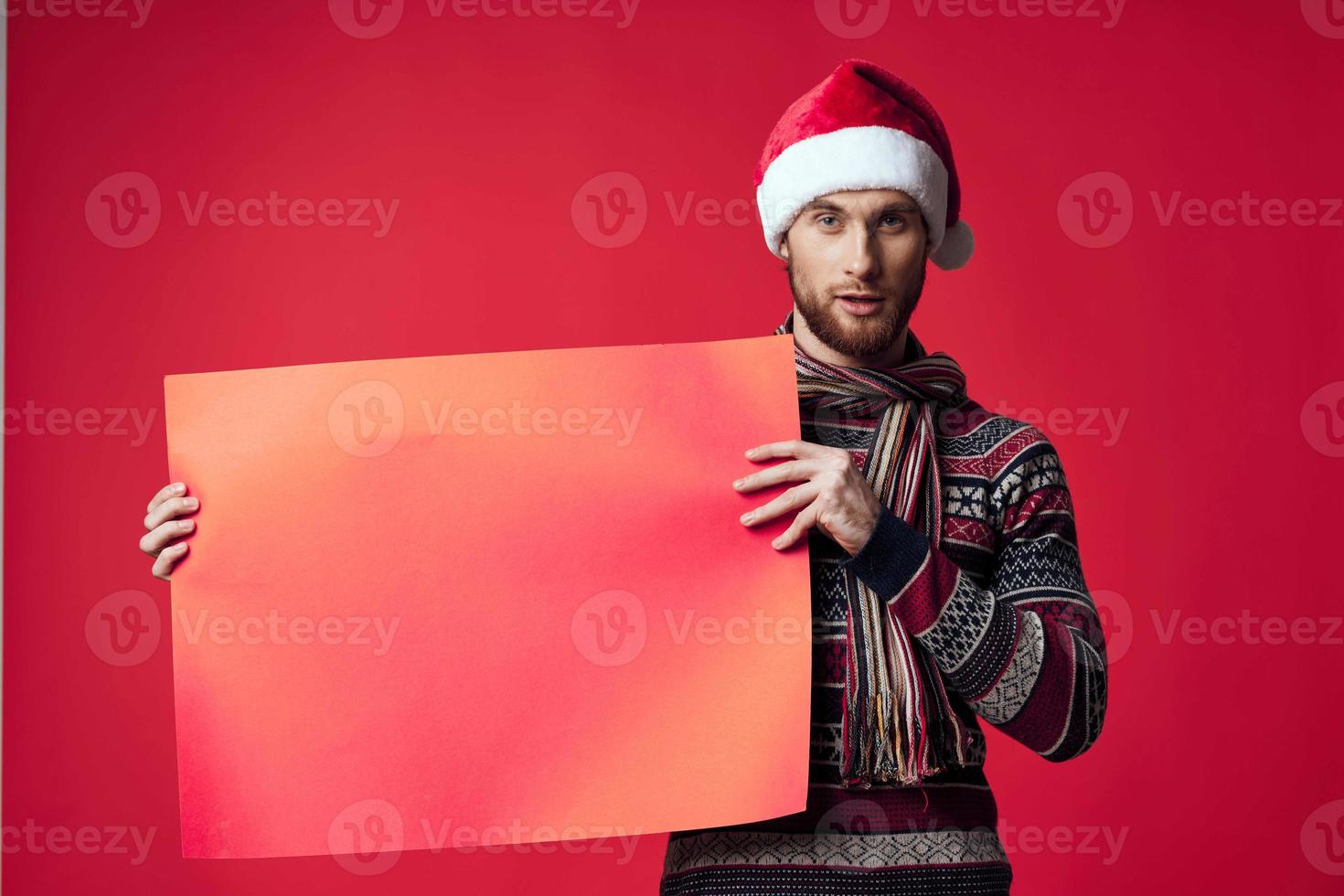 Cheerful man in New Year's clothes advertising copy space isolated background photo