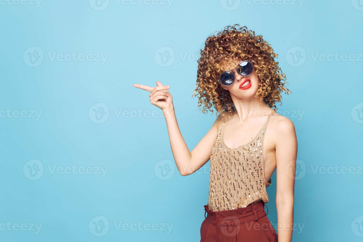 Woman portrait Curly hair shows emotion with a finger to the side photo