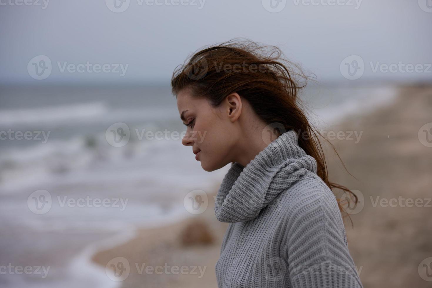 portrait of a woman cloudy weather by the sea travel fresh air Lifestyle photo