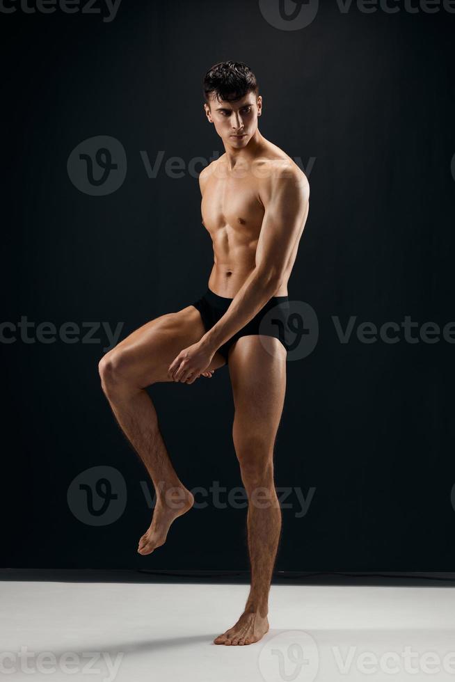 athletic male bodybuilder with muscular body black panties studio photo