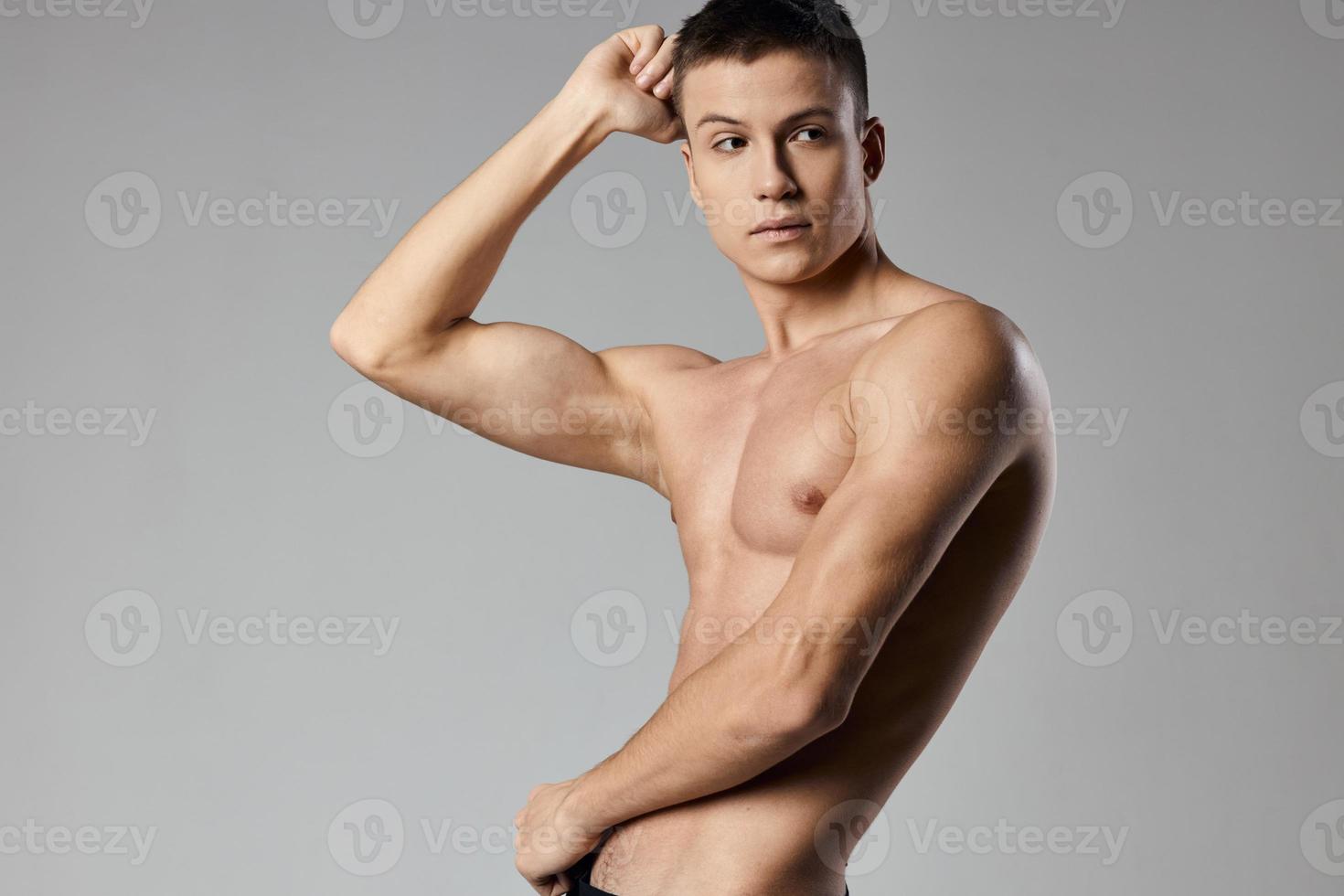 sexy athletes with pumped up arm muscles on gray background cropped view of bodybuilder photo