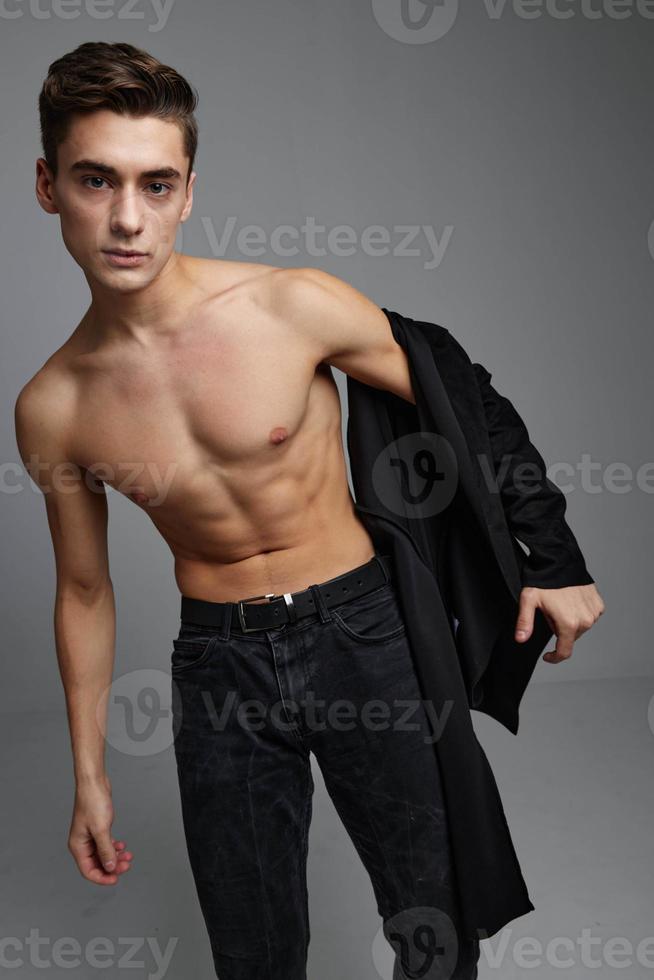 Handsome man with naked body black shirt portrait luxury Studio photo