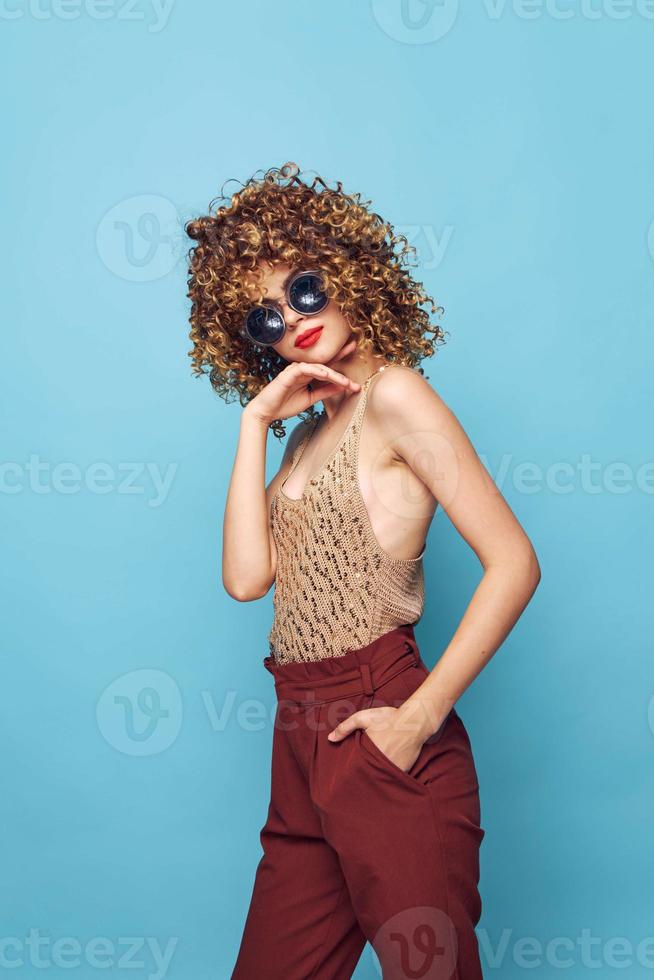 Portrait of a woman Curly hair elegant style blue pattern background bright makeup photo