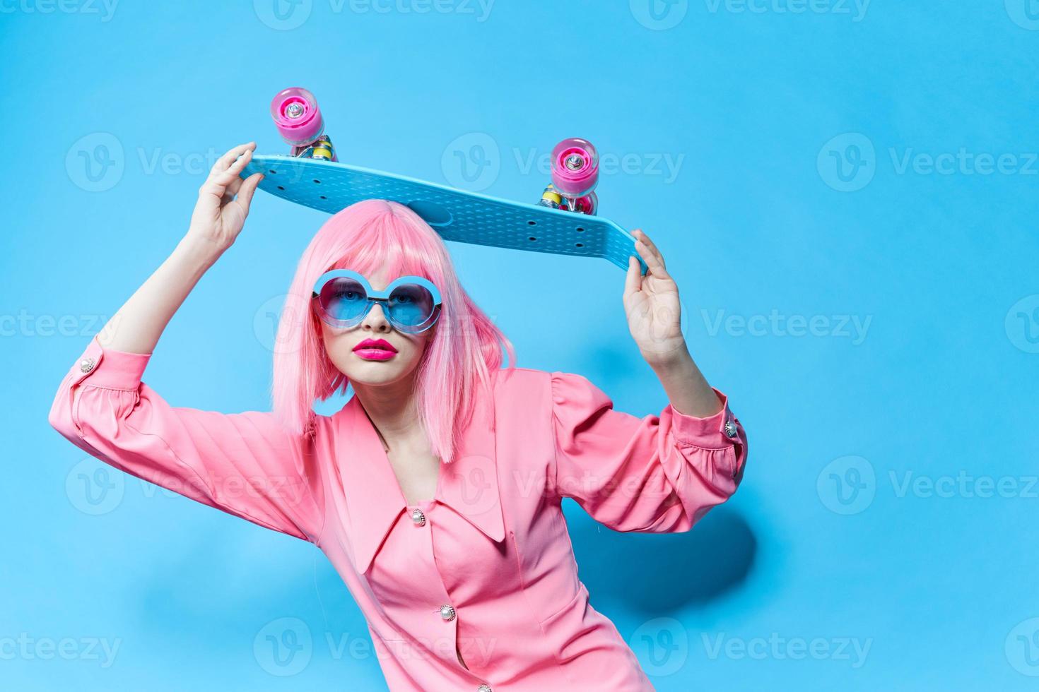 fashionable woman fashion blue glasses skateboard isolated background photo