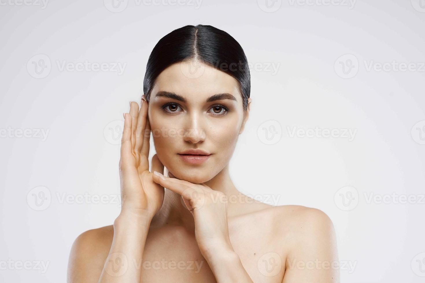 pretty woman naked shoulders face skin care light background photo