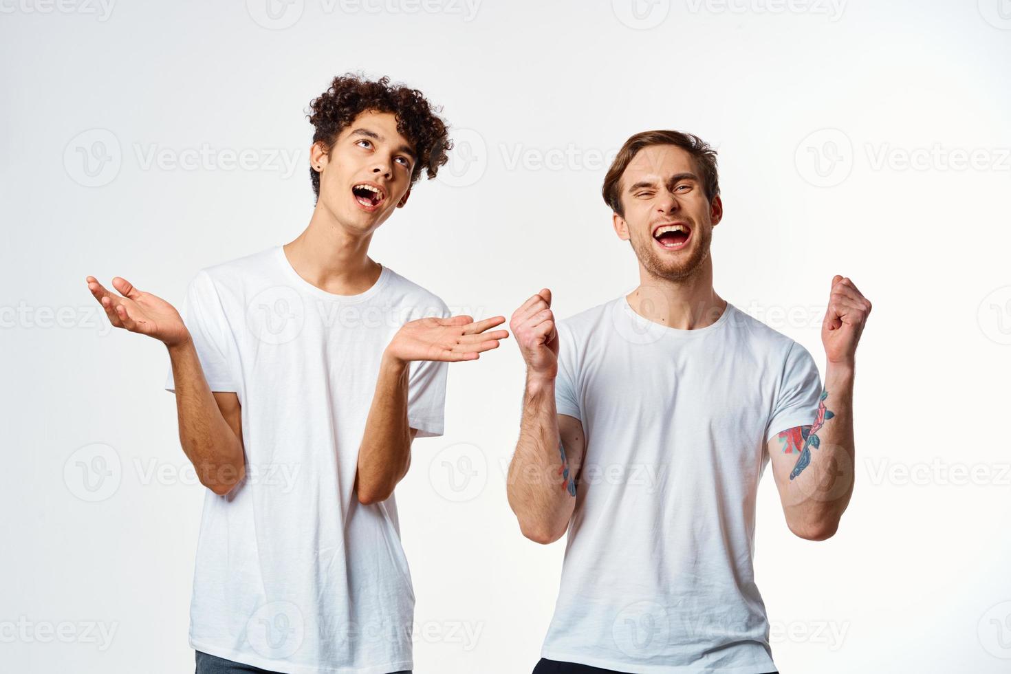 two funny friends in white t-shirts laughing positive emotions photo