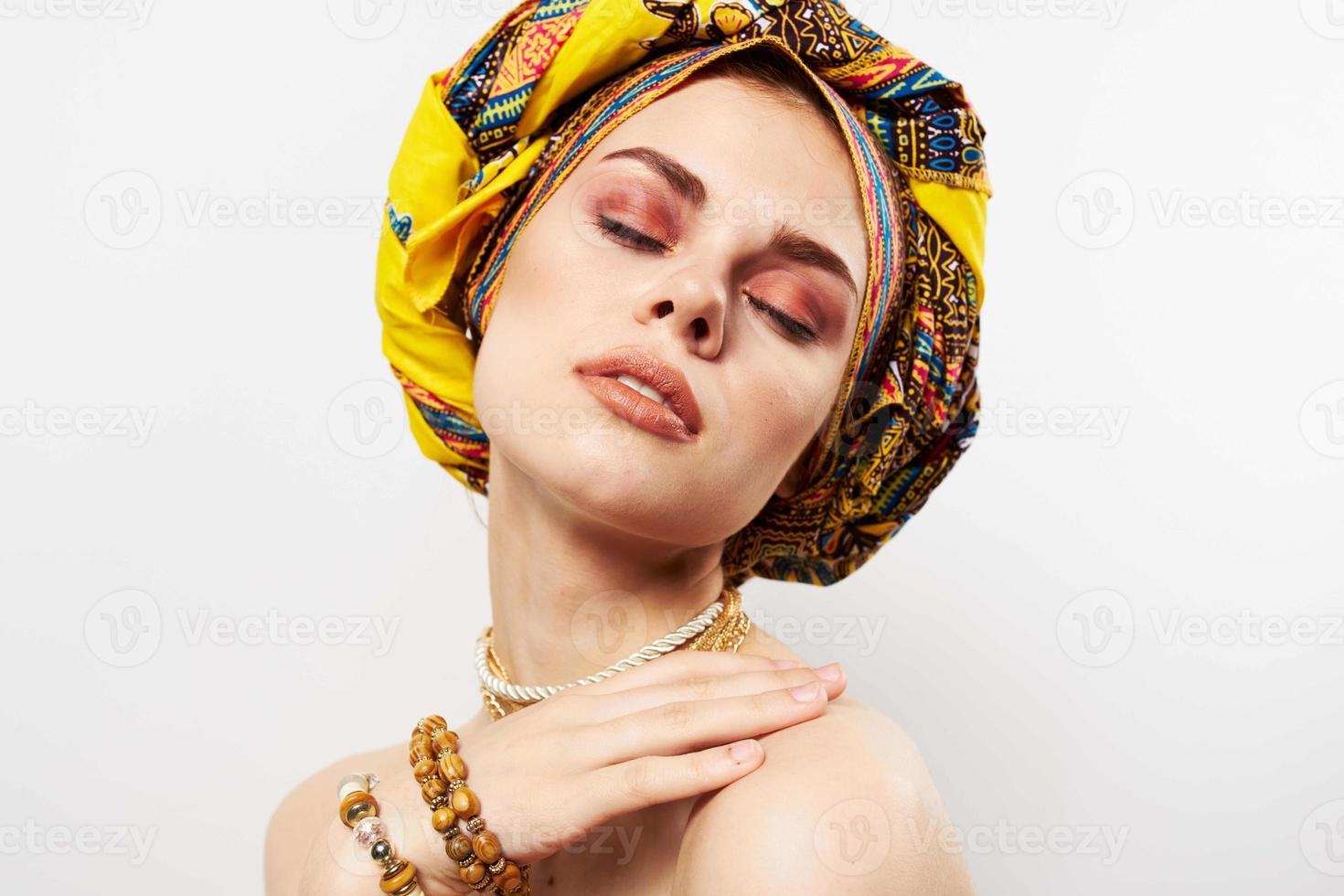 cheerful woman with multi-colored turban on her head decoration posing photo