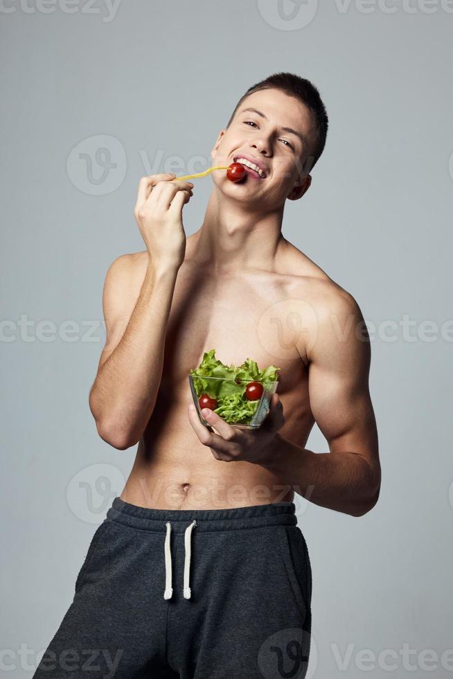 handsome man with pumped body healthy eating lifestyle isolated background photo