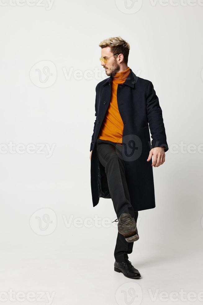 energetic man in orange sweater modern adult man suit coat pant photo