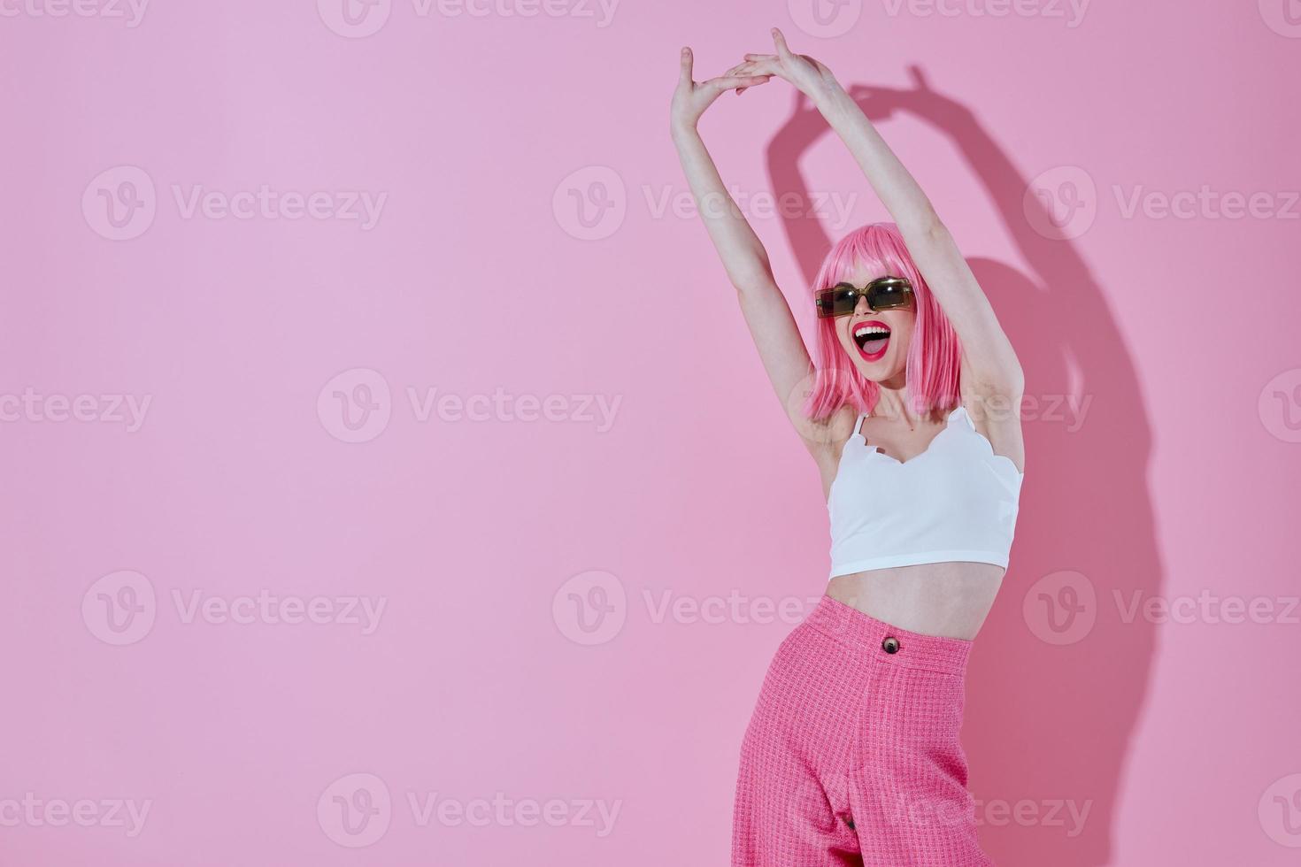 Positive young woman in a white T-shirt and pink pants glamor studio model unaltered photo