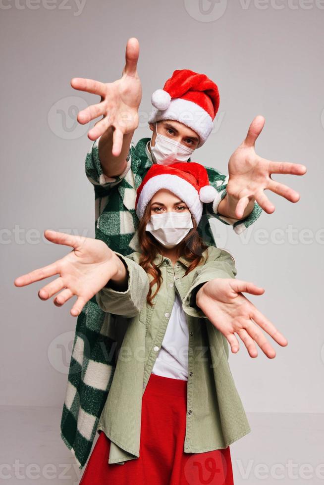 Cheerful medical masked Christmas hats holiday fun New Year photo