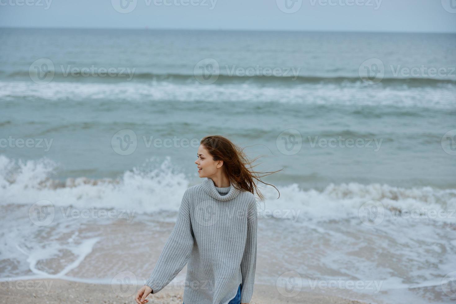 pretty woman alone by the ocean cloudy weather Happy female relaxing photo