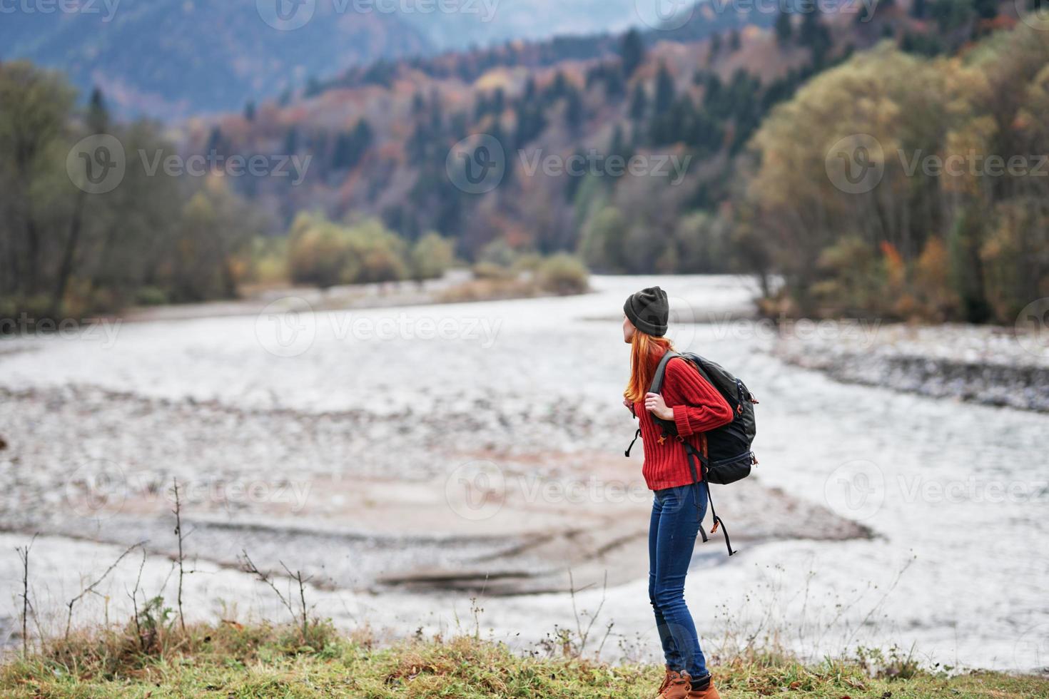 hiker with a backpack on the banks of the river in the mountains and landscape morning model tourism photo