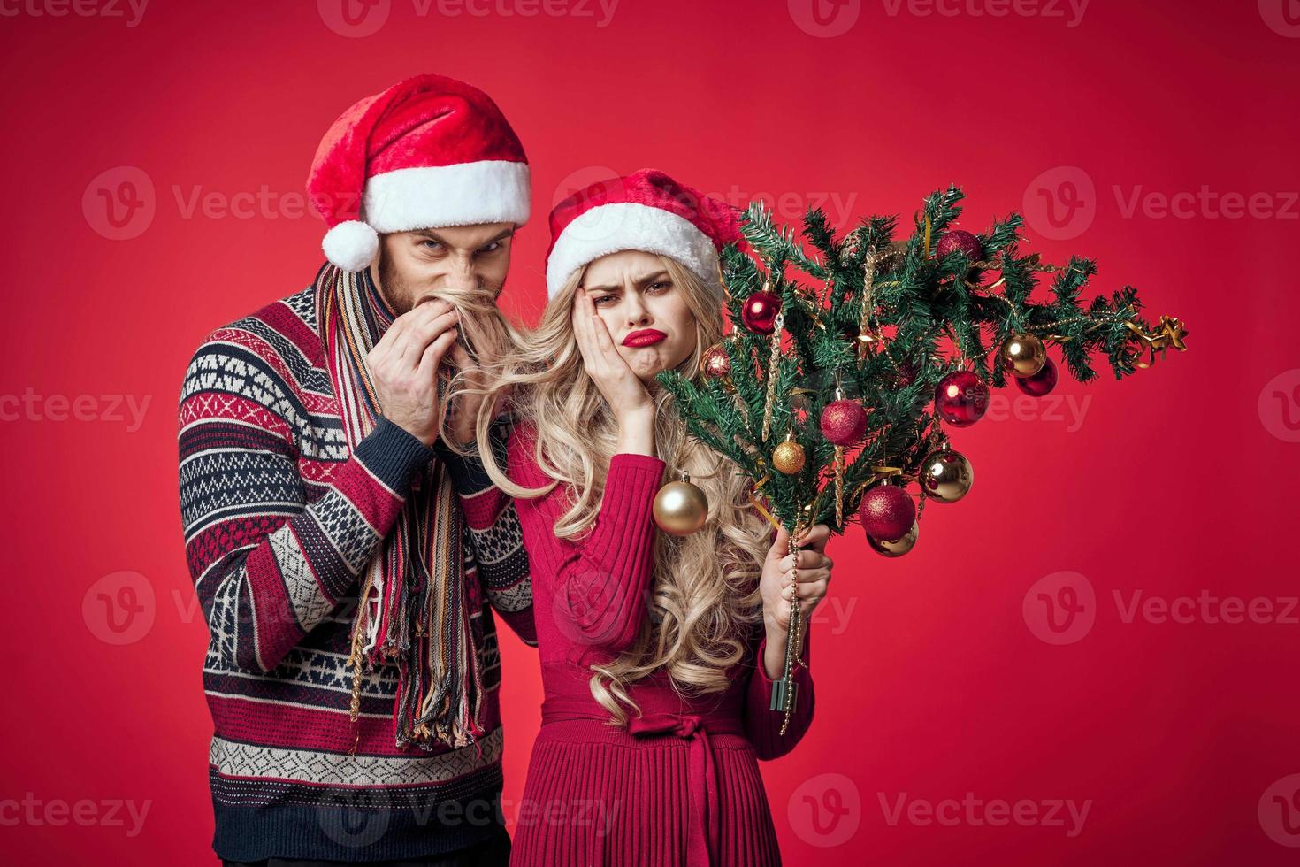 young couple celebrate christmas together decoration red background photo