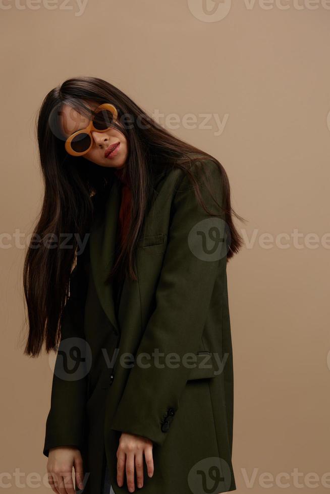 Brunette in a stylish suit in black glasses posing isolated background photo