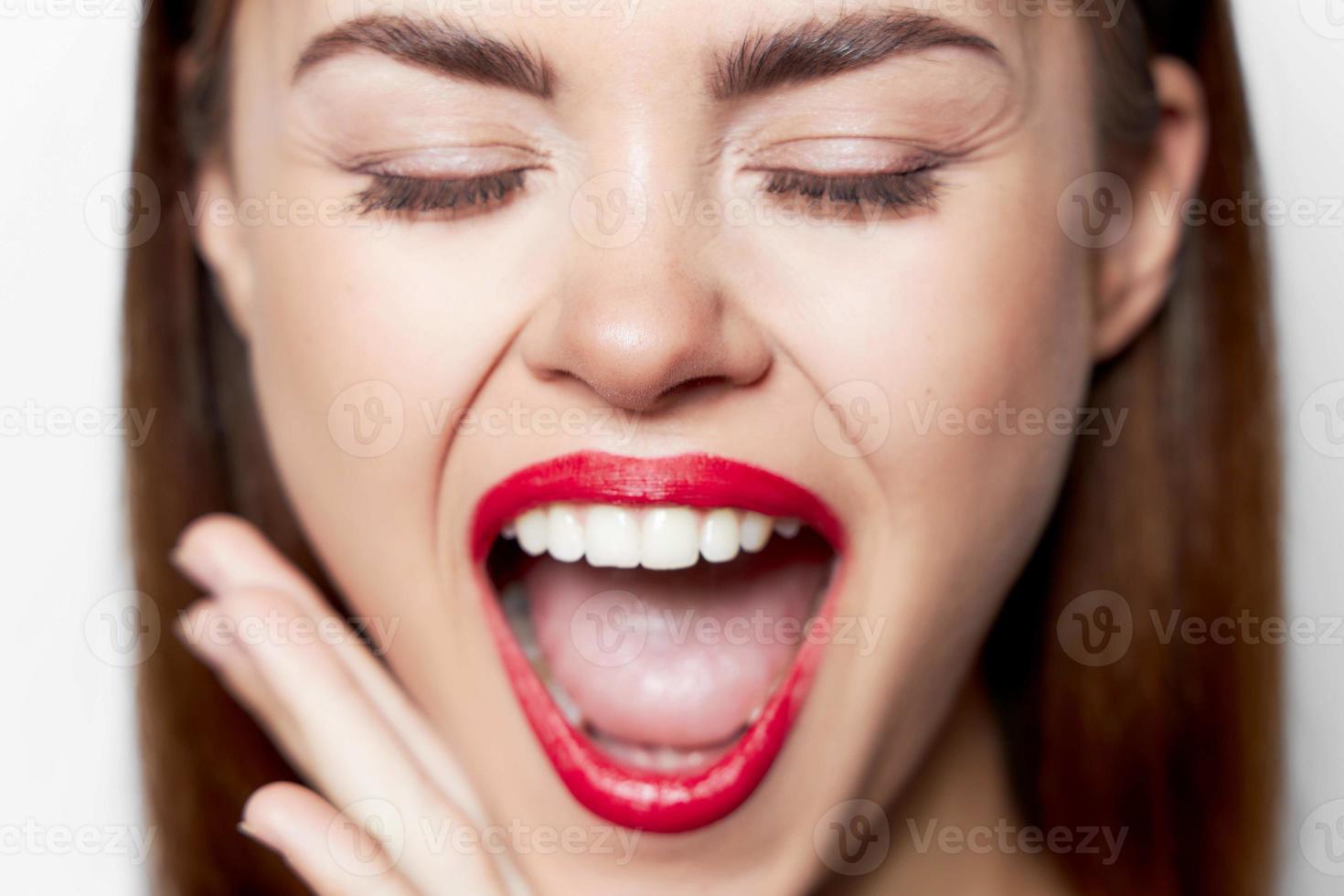 woman face close-up red bites her lip photo