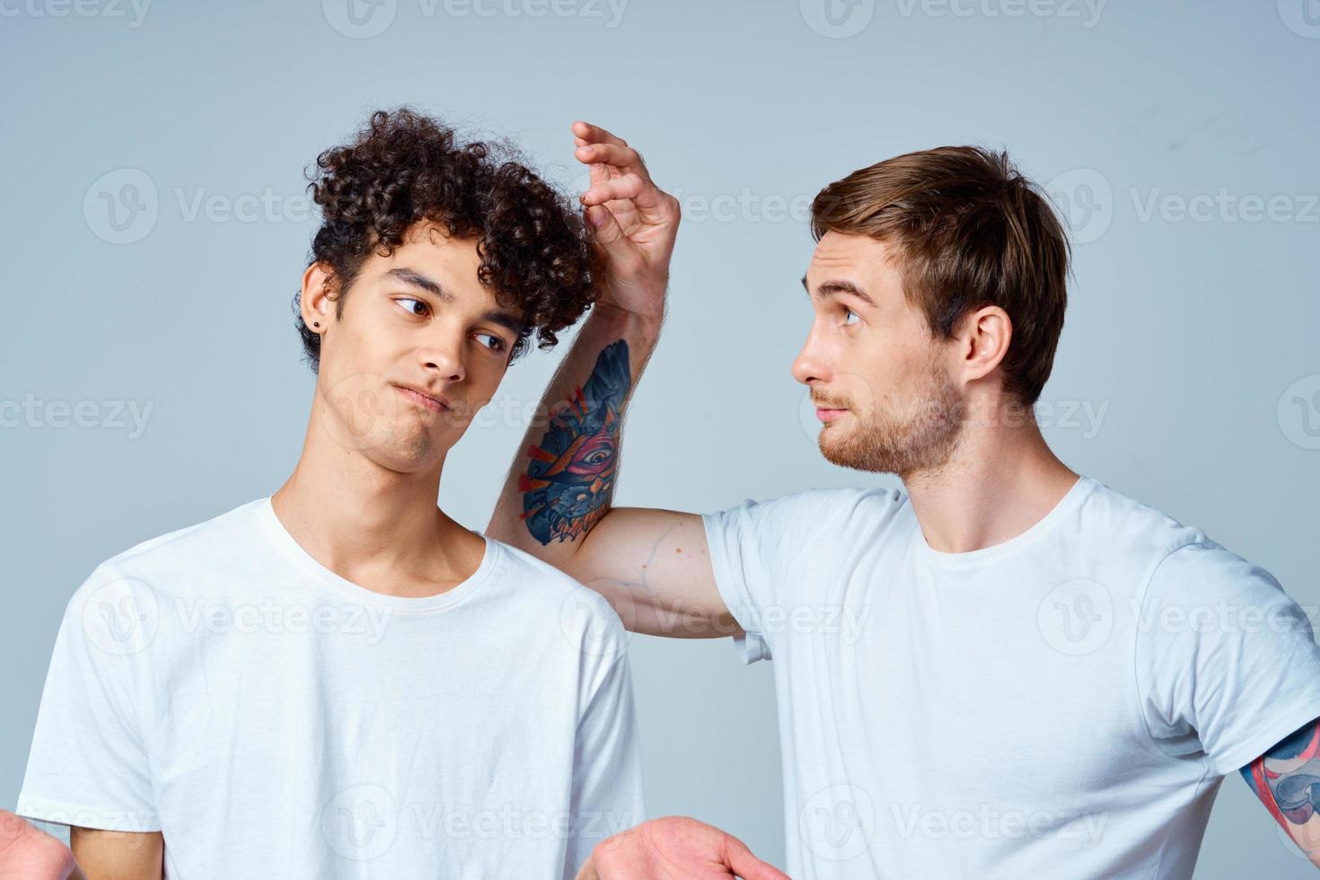 emotional two friends in white t-shirts yes fun studio photo