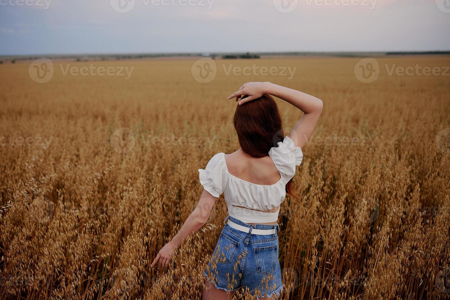 woman walking in the field landscape freedom back view photo