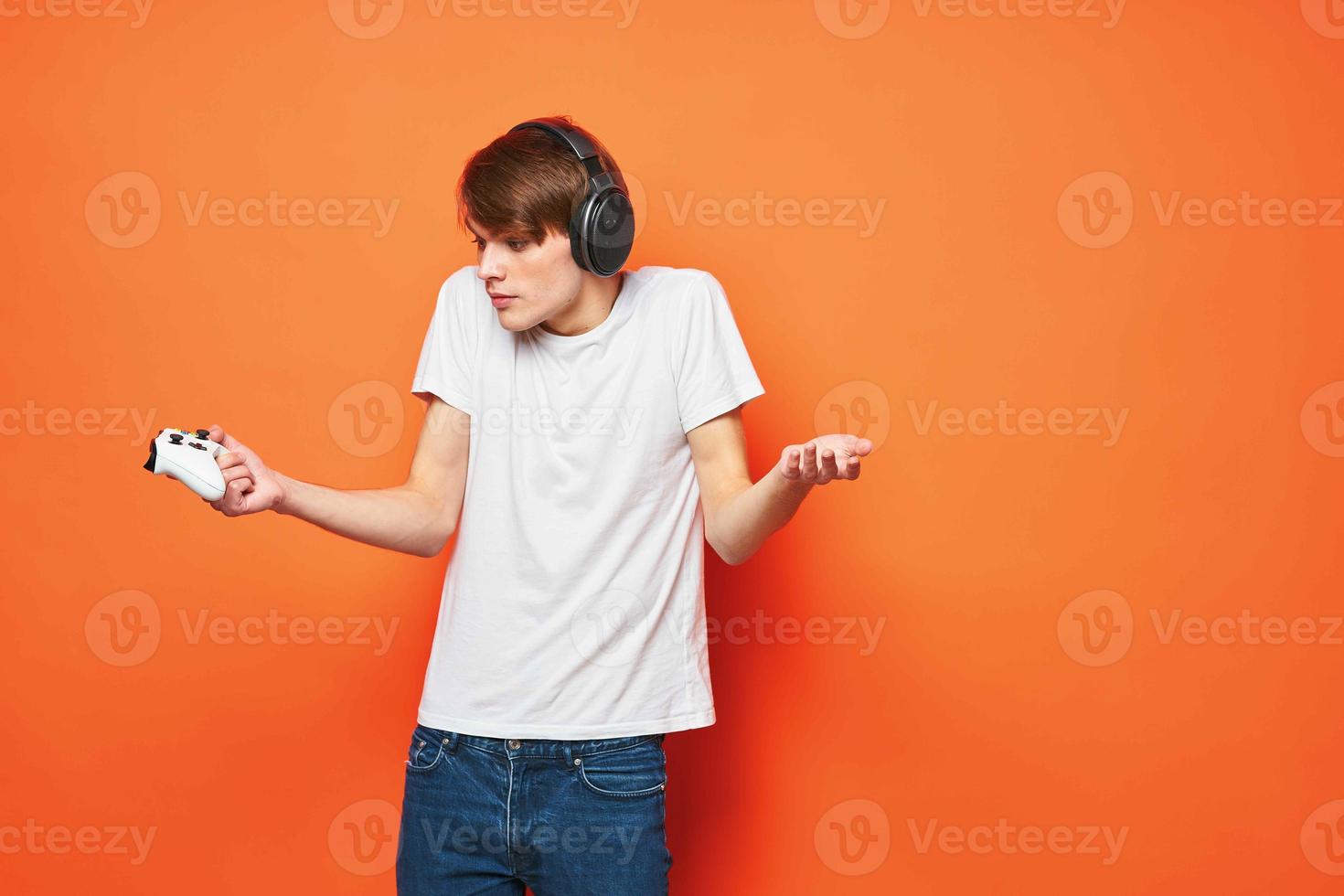 guy in a white t-shirt with a joystick in his hands entertainment games technology photo