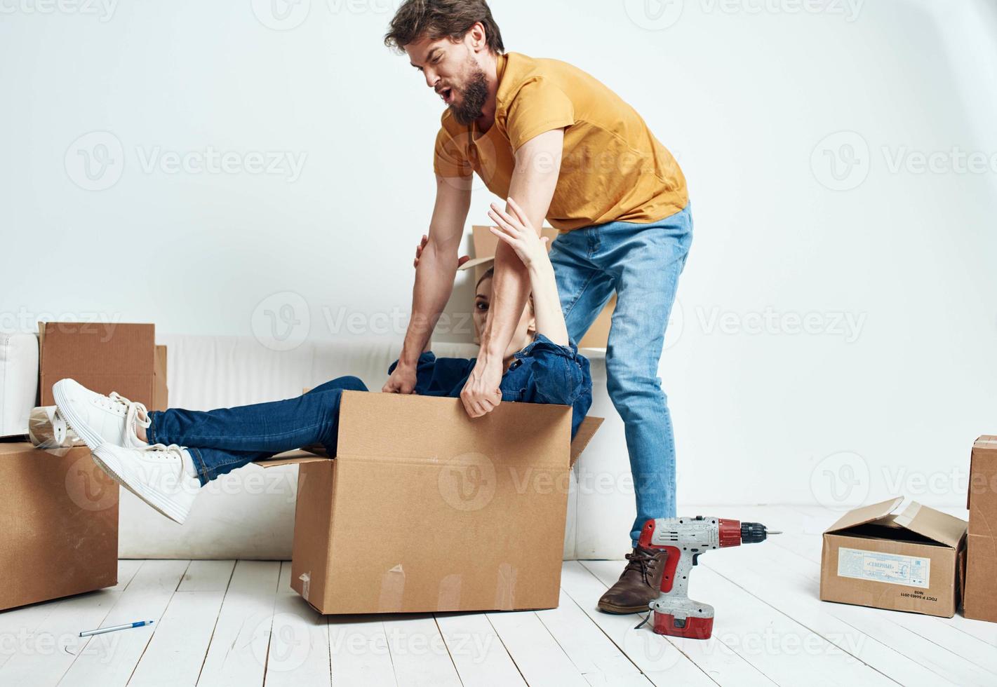 young married couple boxes with things moving room interior fun photo