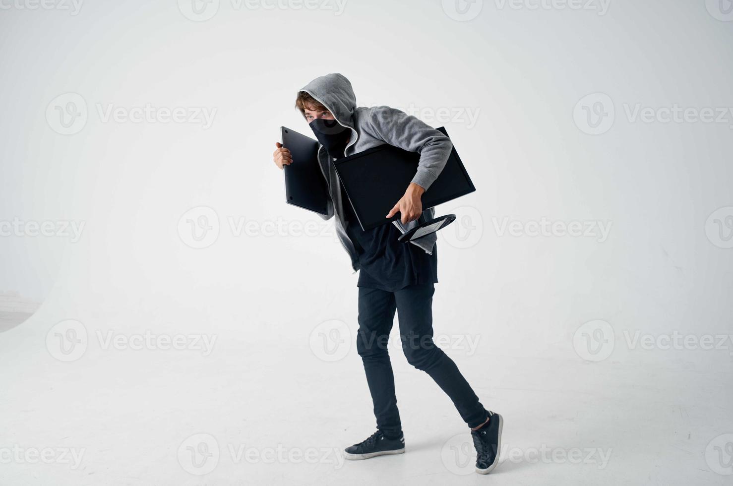 masked man crime anonymity caution balaclava light background photo