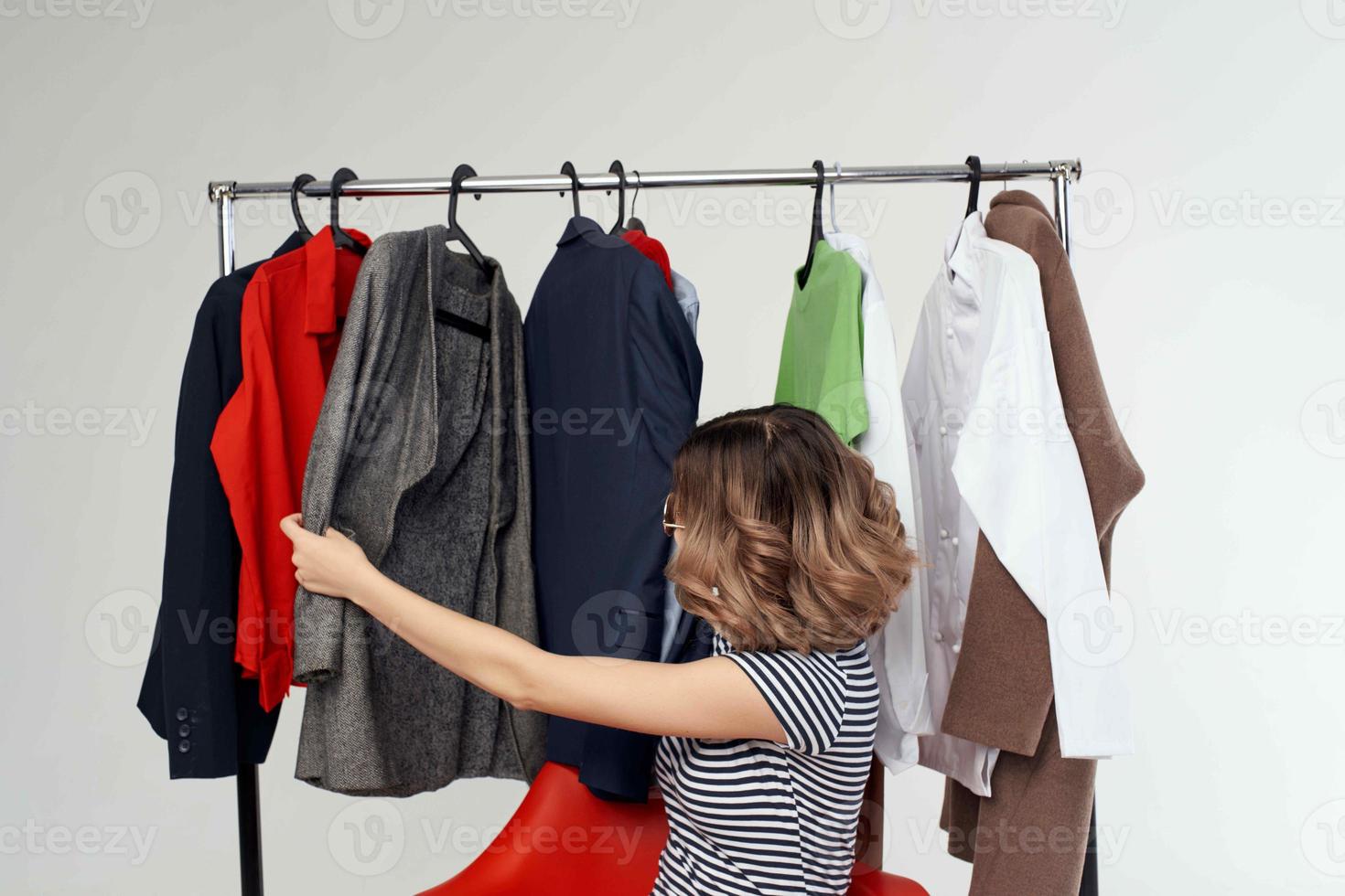 cheerful woman with glasses next to clothes fashion fun emotions photo