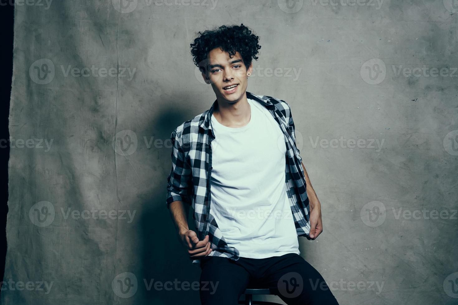 cute guy plaid shirt fun curly hair studio lifestyle photo