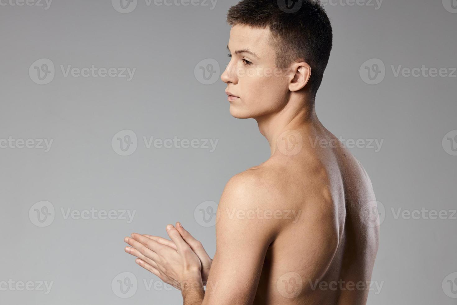strong athlete with bulging arm muscles naked back back view photo