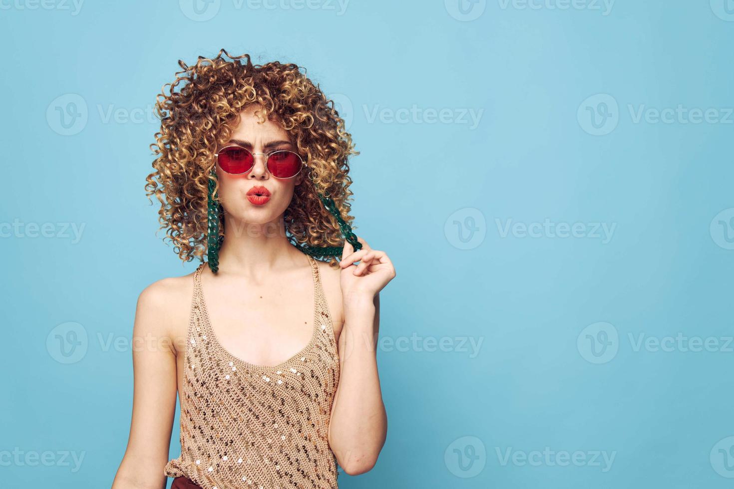 Pretty lady hand gestures on an isolated blue background photo