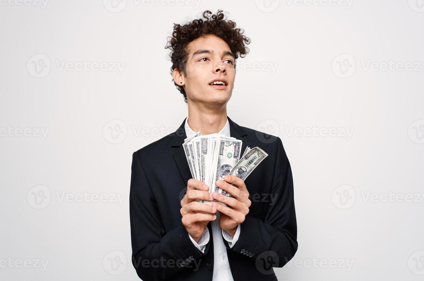 Cheerful man in a suit with money in the hands of a finance official photo