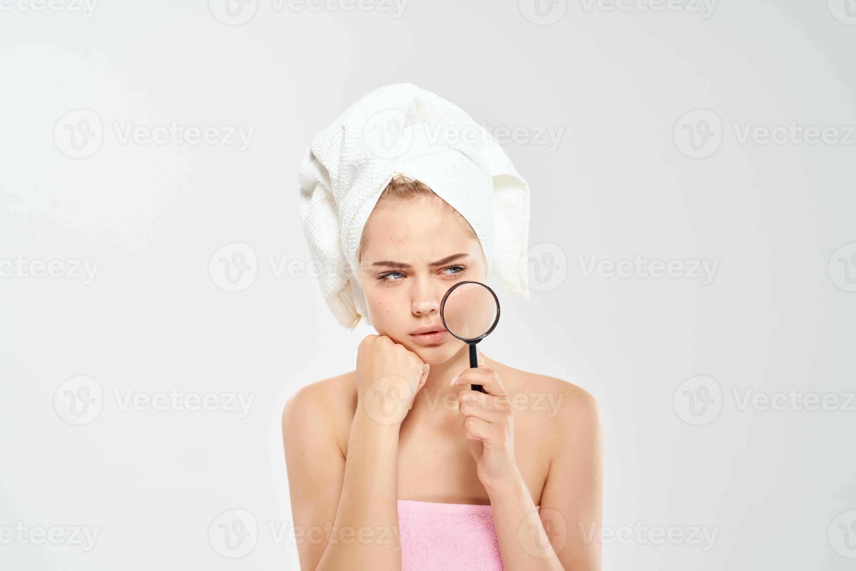 surprised woman with bare shoulders clean skin magnifying glass in